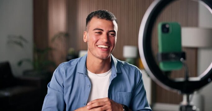 Phone, ring light and man with welcome for live stream, content creation and social media in home. Streamer, influencer and gen z person with tech for broadcast, performance and online introduction