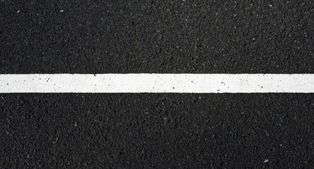 Fototapeta premium Bright white stripe on newly laid black asphalt surface