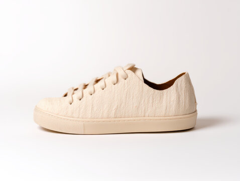  minimalist beige textured casual sneaker with laces, displayed on a plain white background.