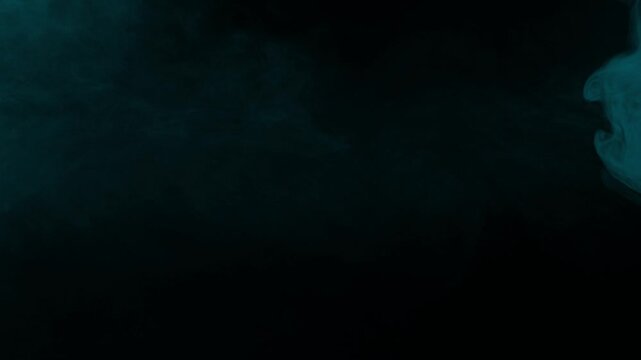 A single wisp of cyan smoke drifts slowly, ideal as an isolated vfx element for compositing on black background
