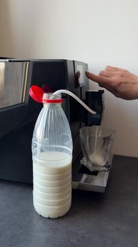 Adjusting milk foam settings on an automatic coffee machine. Close-up of a hand using the touch screen to customize coffee strength and milk volume. Modern barista technology at home.