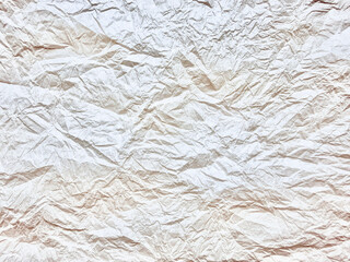 crumpled white paper texture showcases deep organic creases and soft neutral shadows in hyper detailed abstract macro