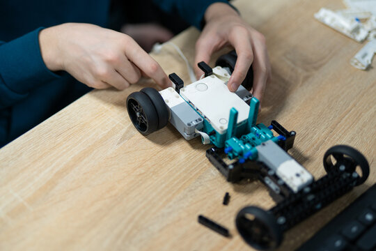 Student assembling a programmable robot car