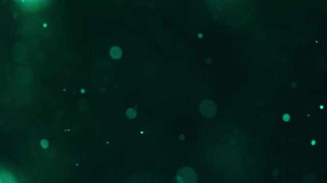 Gentle Shimmering Teal Particles Glide Above Dark Textured Surfaces Offering Peaceful Ambiance