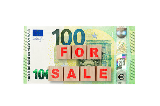 Wooden cubes with word FOR SALE on a 100 euro background