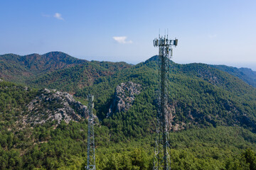 Obraz premium Cell site of telephone tower with 5G base station transceiver. Aerial view of telecommunication antenna mast