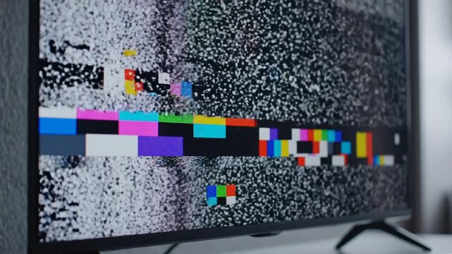 Television Screen Displaying Static and Color Bars Test Pattern.