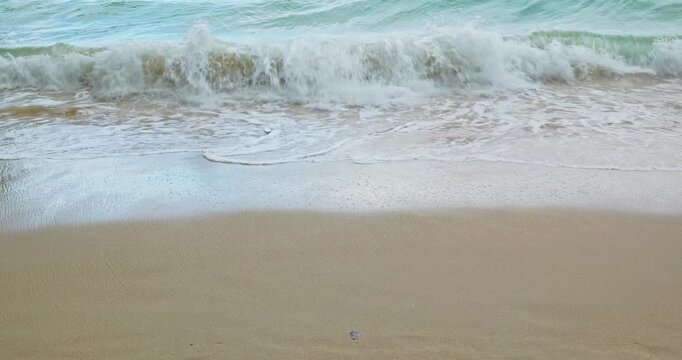 Waves arriving to the sand of the beach in Railay Beach, Thailand