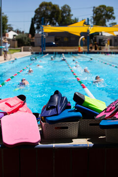 baskets filled with swim training equipment like flippers and snorkels with swim squad in background