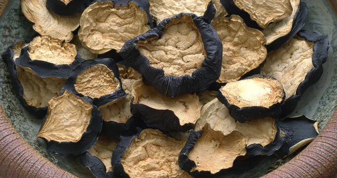 Dried eggplant slices in a handmade clay bowl. Zoom in while rotating.