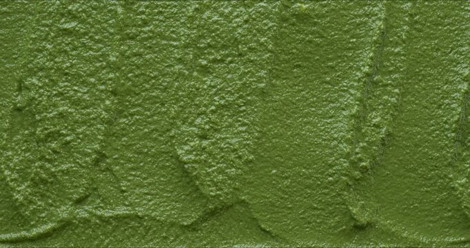 A pesto-like arugula dip background texture. Table spin.