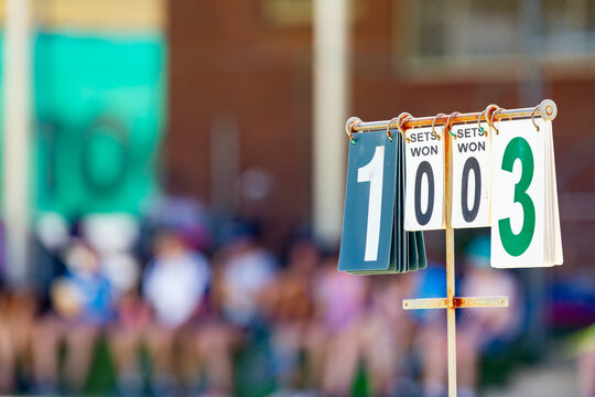 Rural town tennis court with scoring system showing sets won