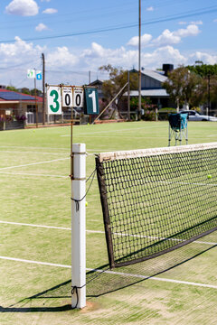 Rural town tennis court with scoring system and net