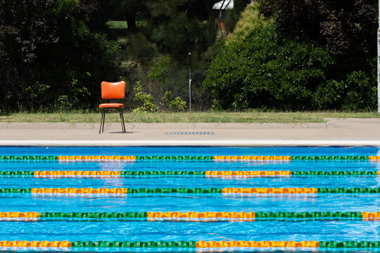 Colourful lane ropes set up in a public swimming pool and chair waiting for a swim competition