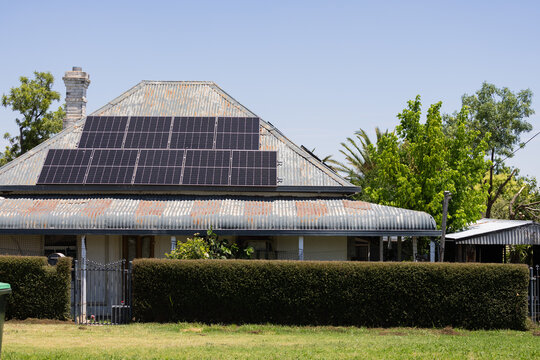 Solar panels on the roof of an older Australian house with bull nose verandah