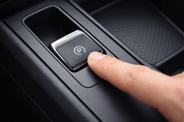 Finger pressing electronic parking brake button in modern car interior. Ai generative
