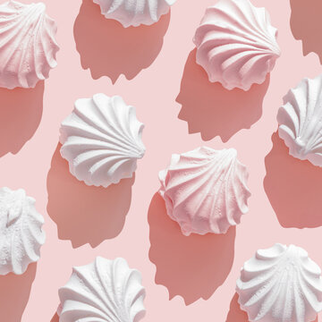 Pink and White zephyr, marshmallow on Pastel Pink Background, Top view pattern of swirled meringue cookies with sun shadows, minimal flat lay pfoto, sweet dessert, sweetness, childhood nostalgia