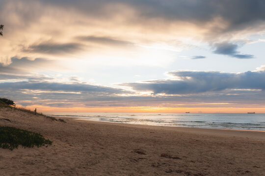 Sunrise at Caves Beach with cargo ships on the horizon