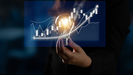 An innovative scene showcasing a hand holding a light bulb illuminated by stock market graphs, illustrating the fusion of creativity and financial growth strategies. Impute © InfiniteFlow
