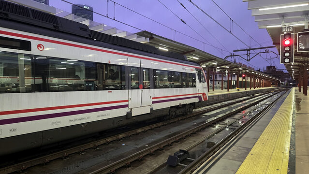 MADRID, SPAIN - FEBRUARY, 25, 2026. Renfe cercanias train at empty urban platform on Chamartin station with wet tracks in spain