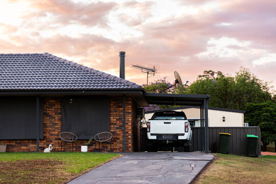 ute parked in carport outside brick suburban house