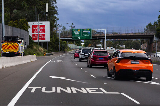 Merging off lane with arrows marked on road towards M11 tunnel in Sydney