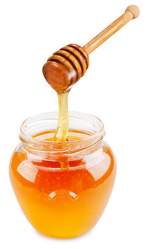 Honey dripping from honey stick into honey pot on a white background. File contains clipping path.