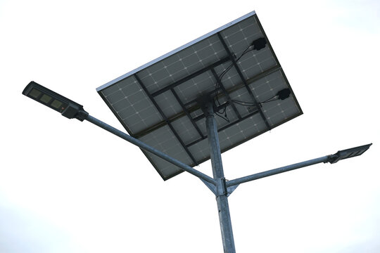 Solar powered street light against cloudy sky