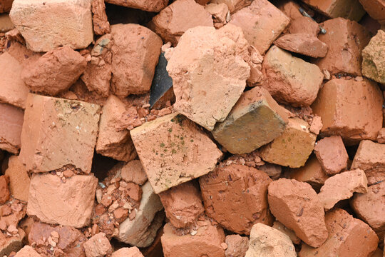 Pile of broken red bricks in various shapes and sizes