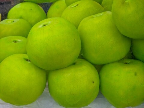 Close-up of plum-soaked guavas on crushed ice, highlighting fresh appearance and cool, crisp texture.