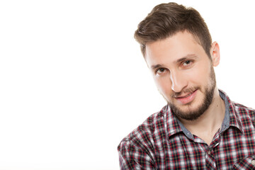 Fototapeta premium Close up portrait of handsome smiling young man with beard wearing plaid shirt looking at camera isolated on white background