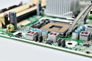 Close-up view of a computer motherboard with CPU socket and electronic components