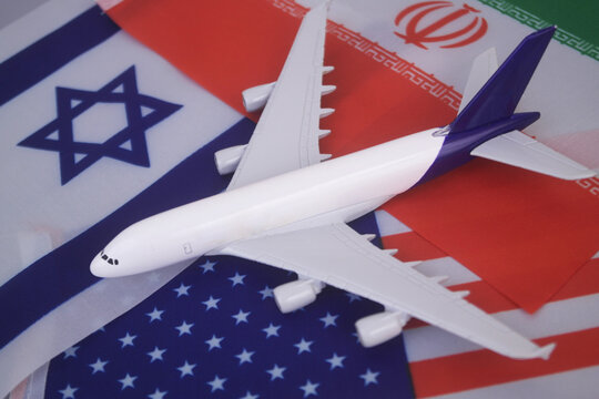 Flags of America, Israel and Iran with airplane. War between US-Israel and Iran concept and flight cancelation.
