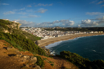Fototapeta premium Dramatic Yellow Cliffs Overlooking Sandy Beach and Turquoise Ocean, Portuguese Coast