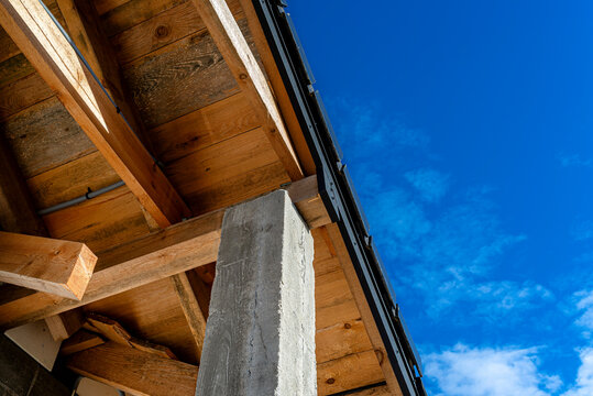 Concrete pillar supporting wooden roof truss construction