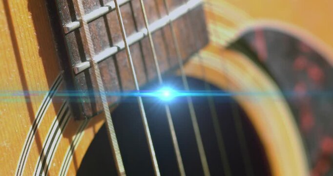 Animation of light flashing over guitar strings moving