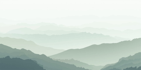 Misty mountain landscape with forest hills and a deep valley under a blue sunrise sky where fog and clouds meet the morning sun. © ATIA