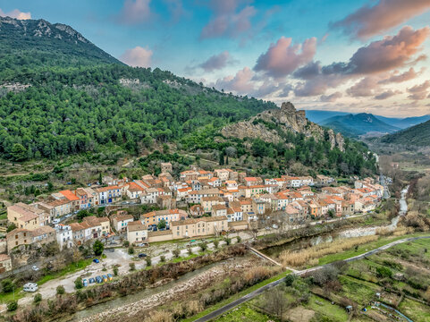 Aerial view of Padern castle and village with colorful sunset sky in France