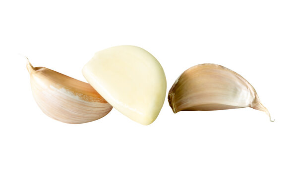 Side view set of three garlic cloves in heap isolated with clipping path in png file format