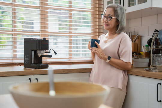 Morning coffee moments woman enjoying a brew in a cozy kitchen lifestyle setting intimate viewpoint
