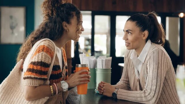 Medium shot of a cruise traveler consulting a roaming specialist about tailored data plans with the traveler in crisp detail and a softly outoffocus travel agency setting.