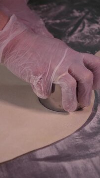 A woman cooks dumplings with meat filling. Vertical video.