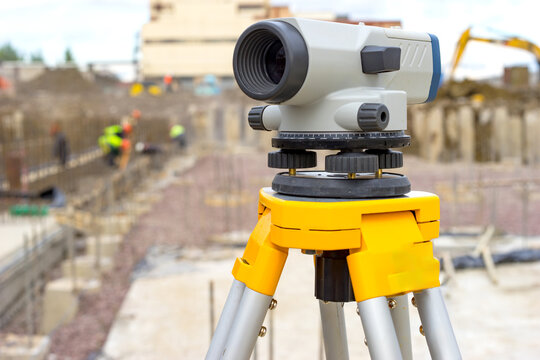 Geodetic surveying, precision optical level positioned to monitor height differences during active construction. Foundation alignment, quality control, engineering measurements.