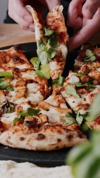 Close up of hands slicing a fresh artisanal sourdough pizza