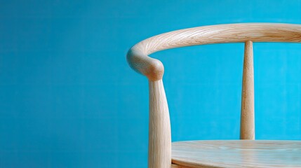 Wooden chair detail against vibrant blue background for minimalist design