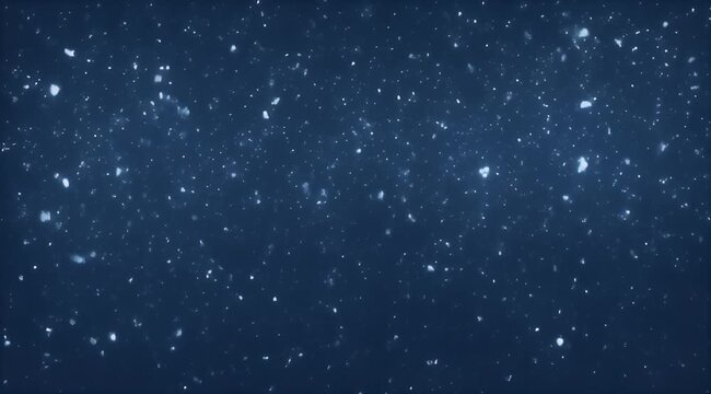 Bright, shimmering particles gently falling against a dark blue, defocused background