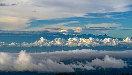 Fototapeta premium Dramatic mountain landscape with layered clouds at sunrise aerial view