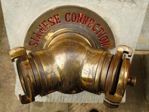 old brass faucet, a Siamese connection, also officially known as a Fire Department Connection (FDC)