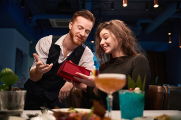 Happy couple celebrating with cocktails in upscale restaurant © Svitlana