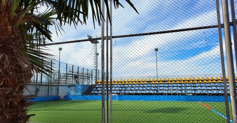 A large football stadium with open stands © Elena